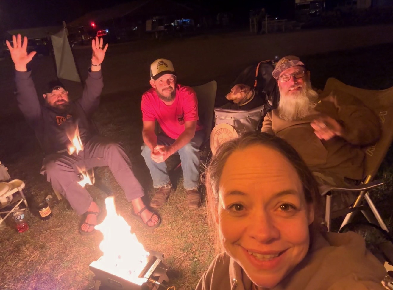 Kris enjoying a cigar with friends around the campfire