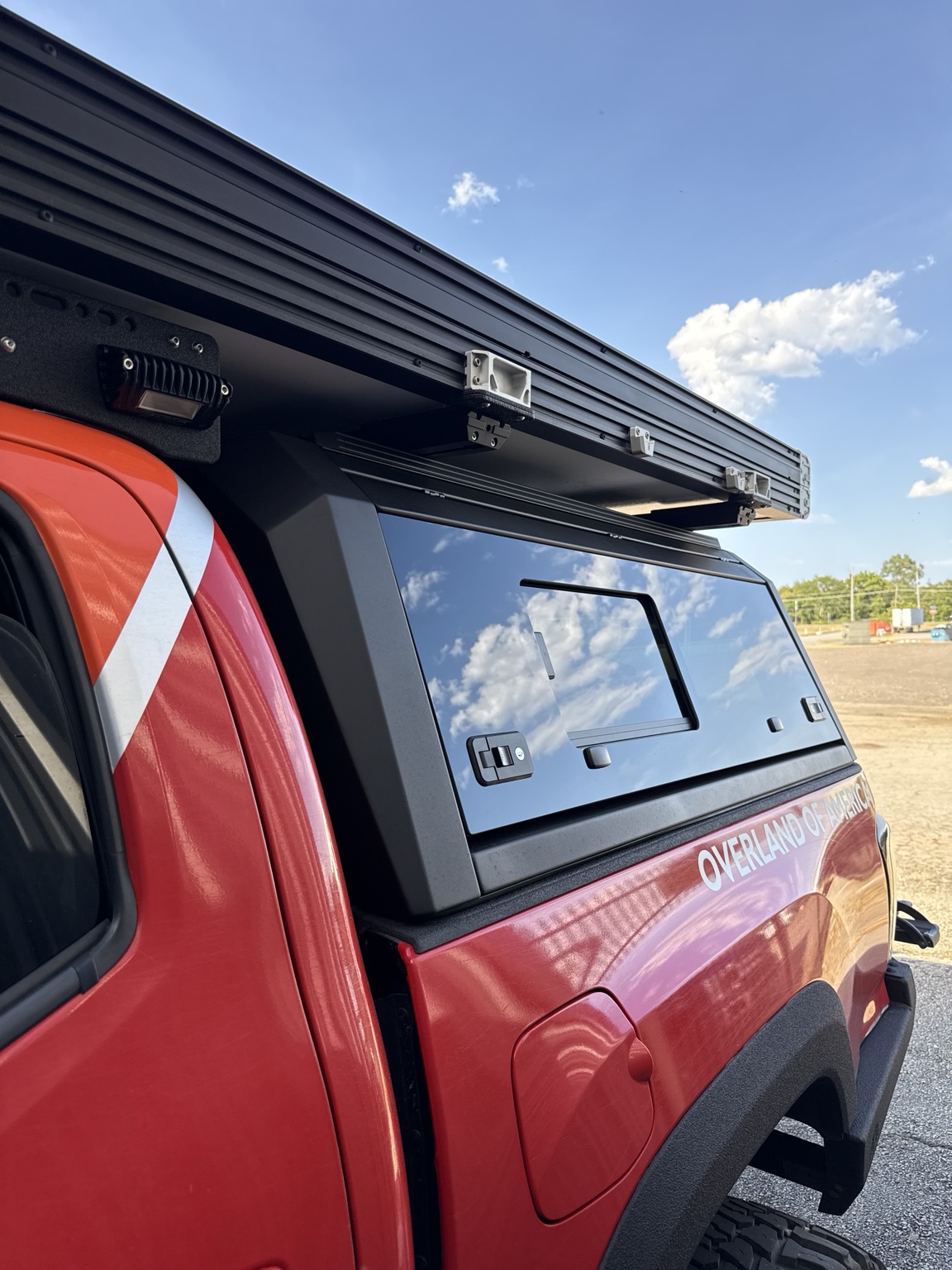 OpenRoad sliding glass truck topper installed on the Fast Rack Overland Tacoma